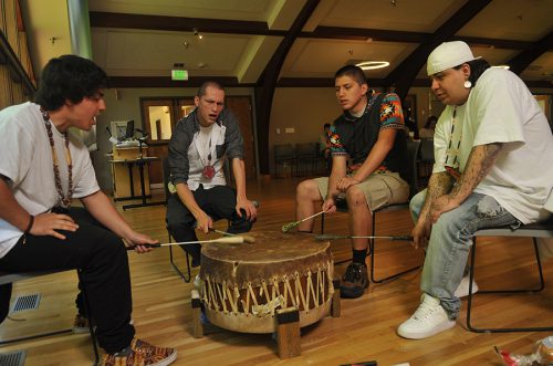 Students at Pow Wow beat a drum